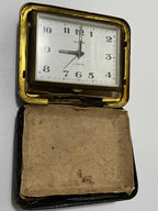 Vintage German Europa travel clock with 2 jewels in a worn protective case, classic square design and gold trim.