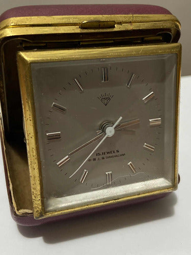 Vintage Shanghai China 15 Jewels mechanical travel clock with gold-tone case in protective leather cover