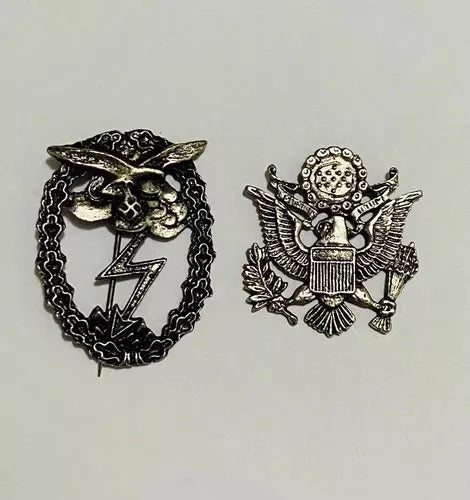 World War II German Luftwaffe badge and United States Army eagle insignia pins side by side on white background