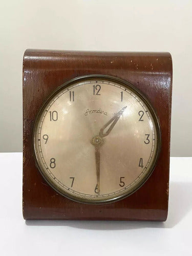 Vintage wooden tabletop clock with round cream dial and classic black numerals and hands.
